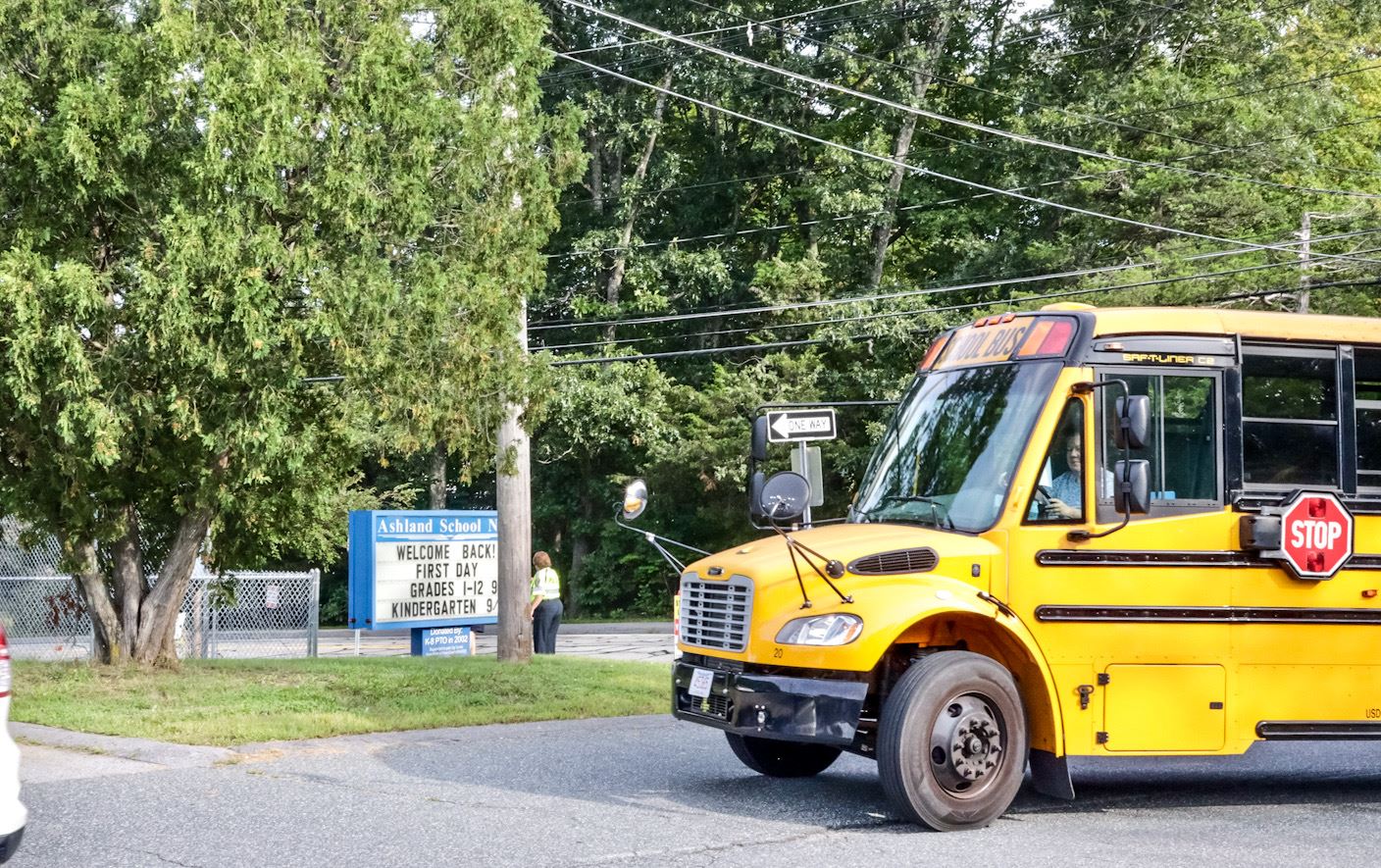 A yellow school bus pulls into the Warren School driveway