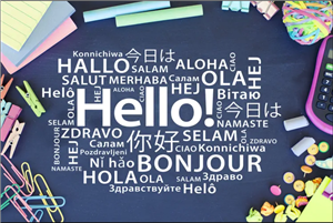 black chalkboard surrounded by school supplies   Hello i different languages with white chalk 